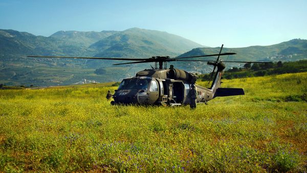 A Sikorsky UH-60 Black Hawk--an optimal helicopter for complex and difficult rescue and transport missions--lands in a Golan Heights field. The Black Hawk helicopter has high maneuverability and survivability, strong engines and high cargo-carrying capacity. The Black Hawk helicopter is also used by the Israeli Air Force to ferry Israeli defense and military officials. - Sputnik International