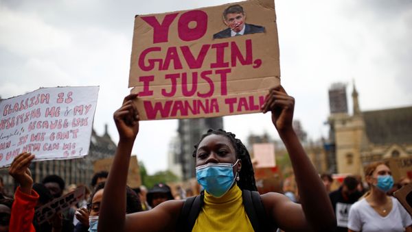 An A level student holds a placard during a protest at Parliament Square, amid the outbreak of the coronavirus disease (COVID-19), in London, Britain, August 16, 2020. - Sputnik International