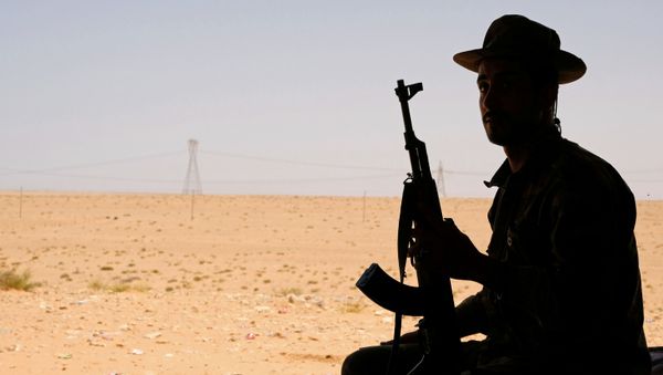 A member of the Libyan National Army (LNA) commanded by Khalifa Haftar sits in a tent at one of their sites in west of Sirte, Libya August 19, 2020 - Sputnik International