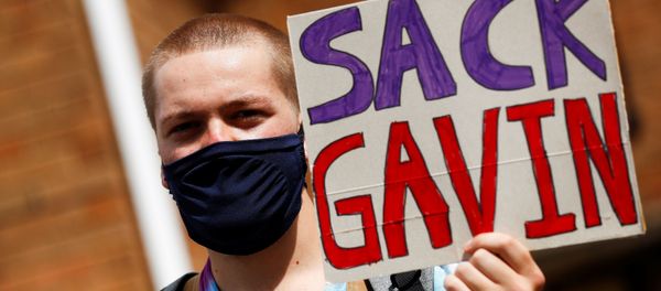 A-level student holds a placard during a protest about the exam results at the constituency offices of Education Secretary Gavin Williamson, amid the spread of the coronavirus disease (COVID-19), in South Staffordshire, Britain, August 17, 2020. REUTERS/Jason Cairnduff - Sputnik International