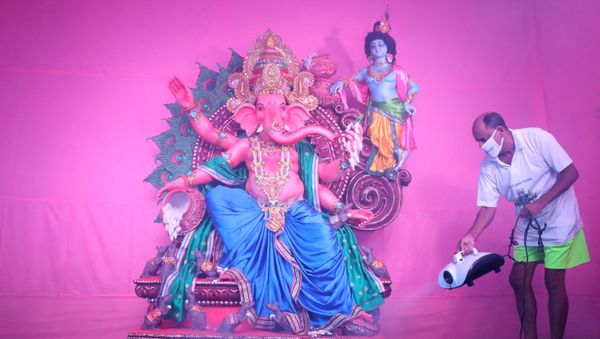 A Hindu devotee wearing a protective mask sanitizes a pandal or a temporary platform, next to an idol of Hindu god Ganesh, the deity of prosperity, ahead of the Ganesh Chaturthi festival, amidst the coronavirus disease (COVID-19) outbreak, in Kolkata, India, August 19, 2020. REUTERS/Rupak De Chowdhuri     TPX IMAGES OF THE DAY - Sputnik International