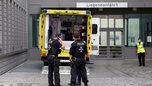 Police officers are seen in front of an ambulance that allegedly transported Russian opposition figure Alexei Navalny to Charite Mitte Hospital Complex where he will receive medical treatment in Berlin, Germany August 22, 2020. Police officers are seen in front of an ambulance that allegedly transported Russian opposition figure Alexei Navalny to Charite Mitte Hospital Complex where he will receive medical treatment in Berlin, Germany August 22, 2020. - Sputnik International