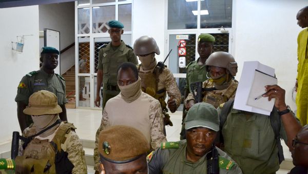 Colonel Assimi Goita, the junta leader of the National Committee for the Salvation of the People (CNSP) which overthrew Mali's President Ibrahim Boubacar Keita, walks out after the meeting with Economic Community of West African States (ECOWAS) mediators in Bamako, Mali August 23, 2020. Colonel Assimi Goita, the junta leader of the National Committee for the Salvation of the People (CNSP) which overthrew Mali's President Ibrahim Boubacar Keita, walks out after the meeting with Economic Community of West African States (ECOWAS) mediators in Bamako, Mali August 23, 2020. - Sputnik International