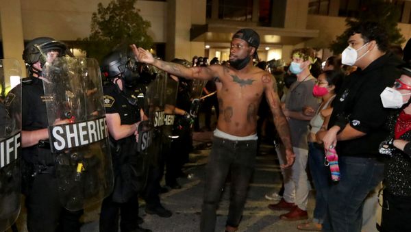 A man confronts police outside the Kenosha Police Department in Kenosha, Wisconsin, U.S., during protests following the police shooting of Black man Jacob Blake August 23, 2020.  - Sputnik International