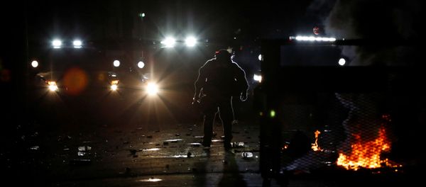 A police officer removes a barricade erected by demonstrators during a protest against police violence and racial injustice in Portland, Oregon, US, August 23, 2020 - Sputnik International