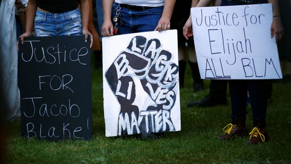 Protesters hold signs calling for justice for Jacob Blake and Elijah McClain at a demonstration against police violence in Denver, Colorado, U.S., August 24, 2020. - Sputnik International
