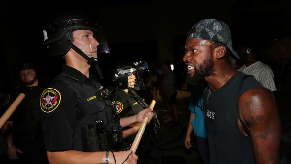 A man confronts police outside the Kenosha Police Department in Kenosha, Wisconsin, U.S., during protests following the police shooting of Black man Jacob Blake, August 23, 2020 A man confronts police outside the Kenosha Police Department in Kenosha, Wisconsin, U.S., during protests following the police shooting of Black man Jacob Blake, August 23, 2020 - Sputnik International