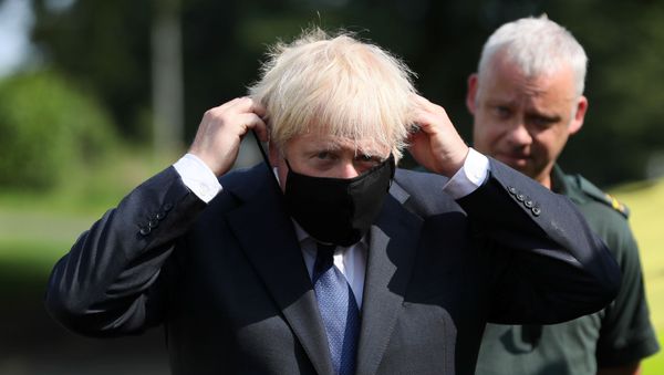 Britain's Prime Minister Boris Johnson puts on a mask at the Northern Ireland Ambulance Service HQ during his visit to Belfast, Northern Ireland August 13, 2020. Britain's Prime Minister Boris Johnson puts on a mask at the Northern Ireland Ambulance Service HQ during his visit to Belfast, Northern Ireland August 13, 2020. - Sputnik International