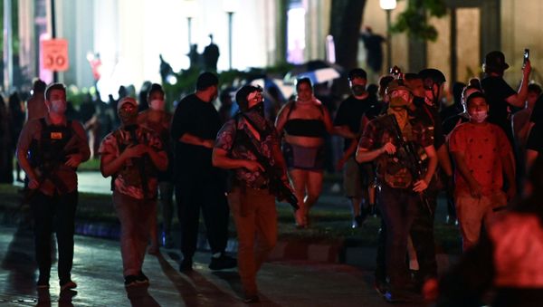 Men carry rifles as people protest outside the Kenosha County Courthouse after a Black man, identified as Jacob Blake, was shot several times by police in Kenosha, Wisconsin, U.S. August 25, 2020. Picture taken August 25, 2020 Men carry rifles as people protest outside the Kenosha County Courthouse after a Black man, identified as Jacob Blake, was shot several times by police in Kenosha, Wisconsin, U.S. August 25, 2020. Picture taken August 25, 2020 - Sputnik International