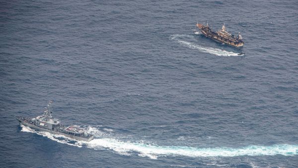 Ecuadorian Navy vessels surround a fishing boat after detecting a fishing fleet of mostly Chinese-flagged ships in an international corridor that borders the Galapagos Islands' exclusive economic zone, in the Pacific Ocean, August 7, 2020 - Sputnik International