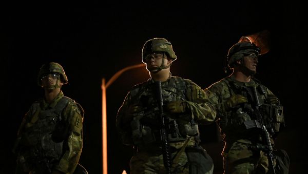 Members of the Wisconsin National Guard keep watch at their post behind the Kenosha Police Department building following the police shooting of Jacob Blake, a Black man, in Kenosha, Wisconsin, U.S., August 27, 2020. - Sputnik International