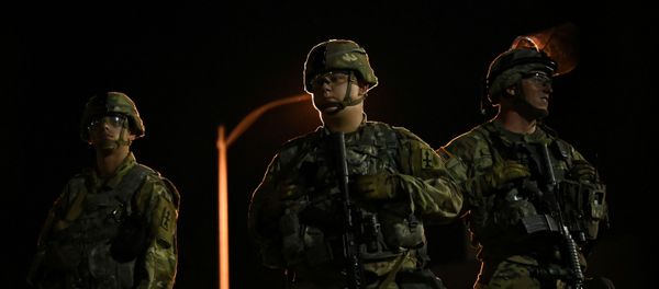 Members of the Wisconsin National Guard keep watch at their post behind the Kenosha Police Department building following the police shooting of Jacob Blake, a Black man, in Kenosha, Wisconsin, U.S., August 27, 2020. Members of the Wisconsin National Guard keep watch at their post behind the Kenosha Police Department building following the police shooting of Jacob Blake, a Black man, in Kenosha, Wisconsin, U.S., August 27, 2020. - Sputnik International