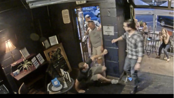 A screenshot from a video showing a customer shoving a bartender in the Golden Moon Speakeasy in the US state of Colorado. - Sputnik International
