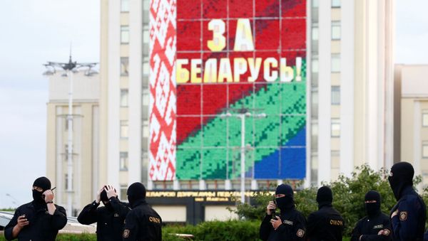 Law enforcement officers are seen during an opposition demonstration against presidential election results at the Independence Square in Minsk, Belarus August 28, 2020. The banner on the building reads: For Belarus! - Sputnik International