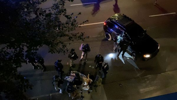 SENSITIVE MATERIAL. THIS IMAGE MAY OFFEND OR DISTURB    Medics and police personnel surround the victim of a shooting in Portland, Oregon, U.S. August 29, 2020, in this still image obtained from a social media video. Courtesy of Sergio Olmos/Social Media via REUTERS. ATTENTION EDITORS - THIS IMAGE HAS BEEN SUPPLIED BY A THIRD PARTY. MANDATORY CREDIT SERGIO OLMOS. NO RESALES. NO ARCHIVES. - Sputnik International