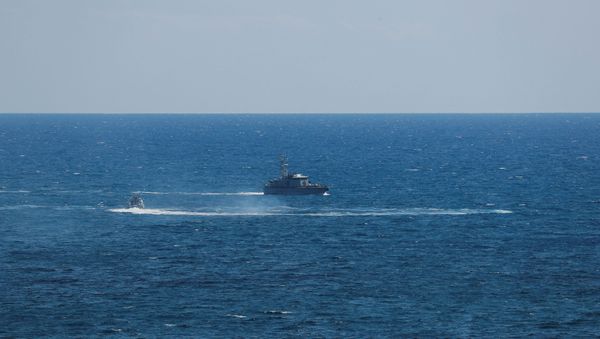 Guardia di Finanza boat is seen after a migrant boat caught fire during rescue operations off the coast of Crotone, with some people still missing according to Italian media, Italy August 30, 2020. REUTERS/Remo Casilli - Sputnik International