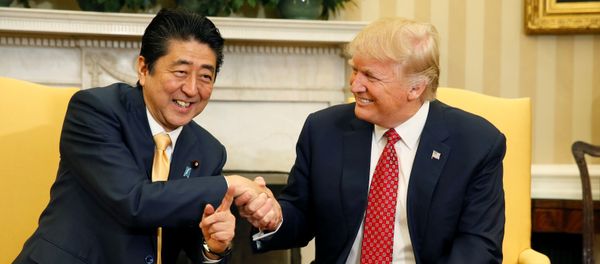 Japanese Prime Minister Shinzo Abe shakes hands with U.S. President Donald Trump (R) during their meeting in the Oval Office at the White House in Washington, U.S., February 10, 2017. - Sputnik International