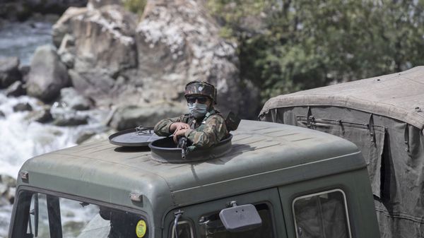 An Indian army soldier keeps guard on top of his vehicle as their convoy moves on the Srinagar- Ladakh highway at Gagangeer, northeast of Srinagar, Indian-controlled Kashmir, Tuesday, Sept. 1, 2020 - Sputnik International