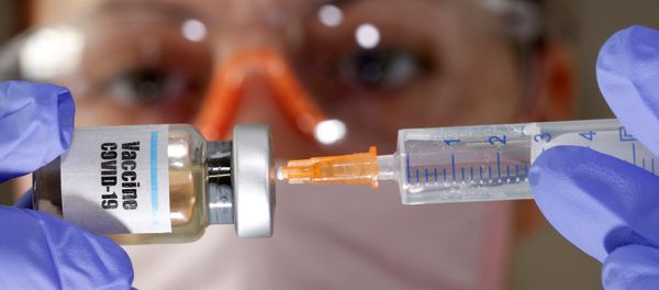 A woman holds a small bottle labeled with a Vaccine COVID-19 sticker and a medical syringe in this illustration taken April 10, 2020. A woman holds a small bottle labeled with a Vaccine COVID-19 sticker and a medical syringe in this illustration taken April 10, 2020. - Sputnik International