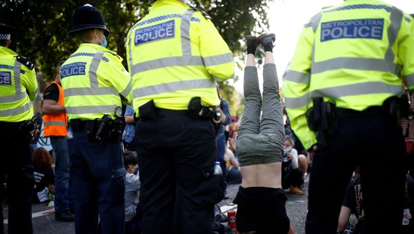 An Extinction Rebellion climate activist stands on their head during a peaceful disruption of British Parliament as lawmakers return from the summer recess, in London, Britain September 1, 2020. - Sputnik International
