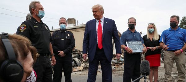 FILE PHOTO: U.S. President Donald Trump talks to reporters as he stands with Kenosha police and business people while examining property damage to a business while visiting the city in the aftermath of recent protests against police brutality and racial injustice and ensuing violence after the shooting of Jacob Blake by a police officer in Kenosha, Wisconsin, U.S., September 1, 2020 - Sputnik International
