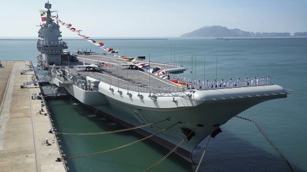 FILE - In this Dec. 17, 2019, file photo provided by Xinhua News Agency, the Shandong aircraft carrier is docked at a naval port in Sanya in southern China's Hainan Province - Sputnik International