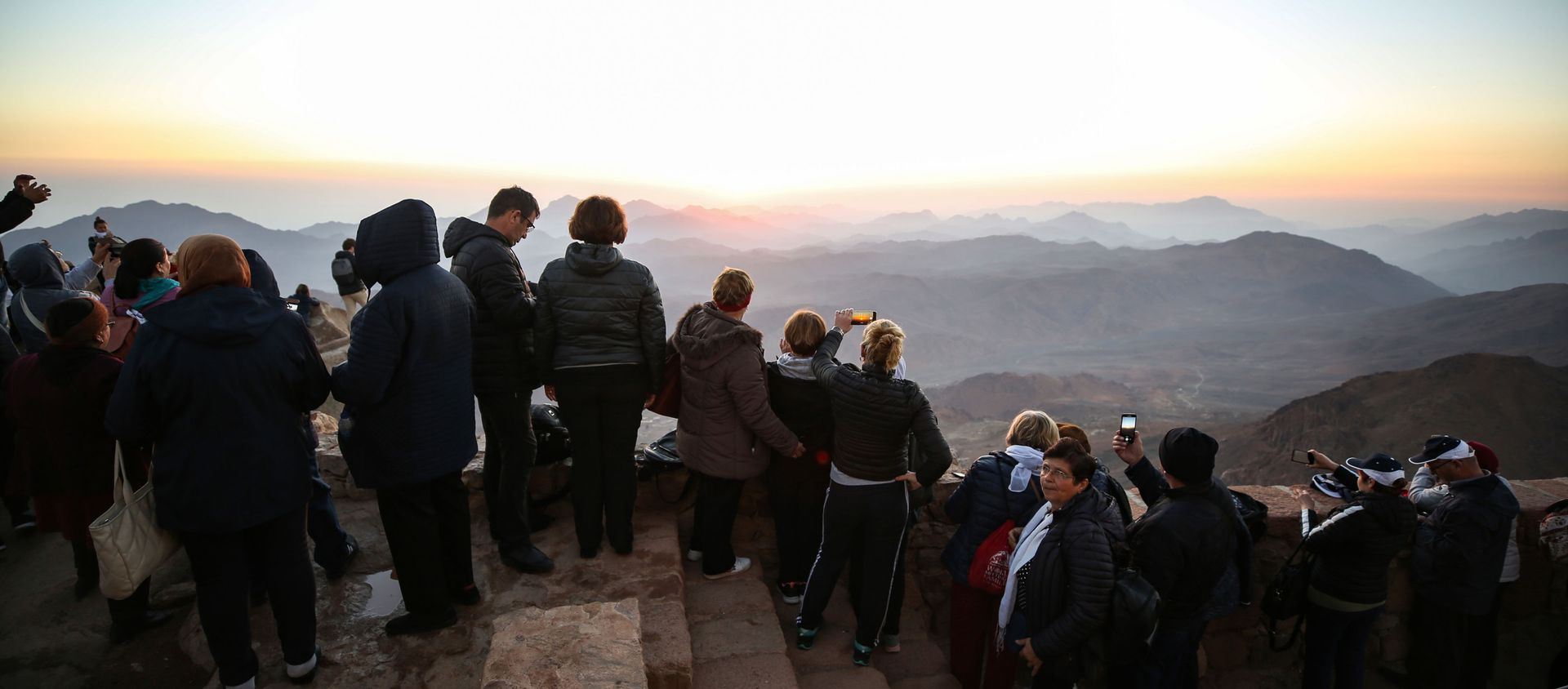 Tourists stand to watch the sunrise after scaling Mount Catherine, above the 6th-century Greek Orthodox Christian monastery of Saint Catherine, near the Egyptian town of the same name in south of the Sinai peninsula, on October 19, 2018, as part of an inter-religious peace conference under slogan Here We pray together.  - Sputnik International, 1920, 03.09.2020