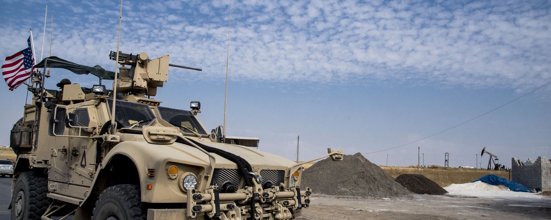 FILE - In this Monday, Oct. 28, 2019 file photo, U.S. forces patrol Syrian oil fields, in eastern Syria.President Donald Trump's decision to dispatch new U.S. forces to eastern Syria to secure oil fields is being criticized by some experts as ill-defined and ambiguous. But the residents of the area, one of the country's most remote and richest regions, hope the U.S. focus on eastern Syria would bring an economic boon and eliminate what remains of the Islamic State group - Sputnik International, 1920, 19.03.2021