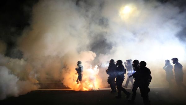 Portland Police officers disperse a crowd of protesters after a Molotov cocktail was thrown on the 100th consecutive night of protests in Portland, Oregon, U.S. September 5, 2020. - Sputnik International