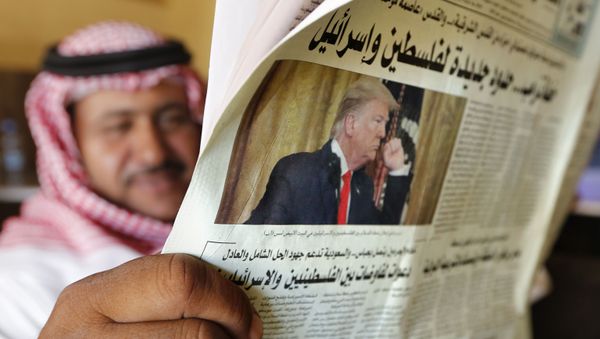 A man holds the daily Asharq Al-Awsat newspaper fronted by a picture of President Donald Trump, at a coffee shop in Jiddah, Saudi Arabia, Wednesday, Jan. 29, 2020 - Sputnik International