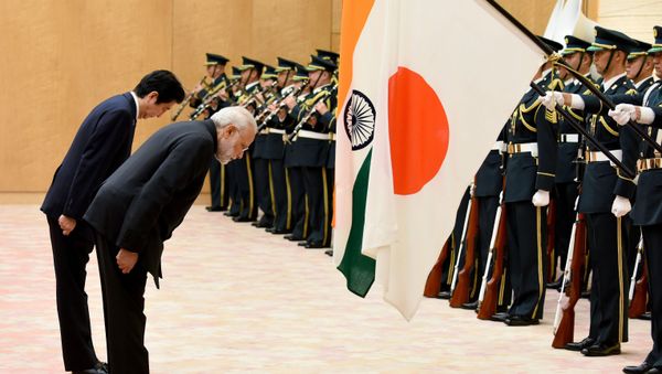 India's Prime Minister Narendra Modi (R) and his Japanese counterpart Shinzo Abe bow to national flags as they review an honor guard before their meeting at Abe's official residence in Tokyo on November 11, 2016 India's Prime Minister Narendra Modi (R) and his Japanese counterpart Shinzo Abe bow to national flags as they review an honor guard before their meeting at Abe's official residence in Tokyo on November 11, 2016 - Sputnik International