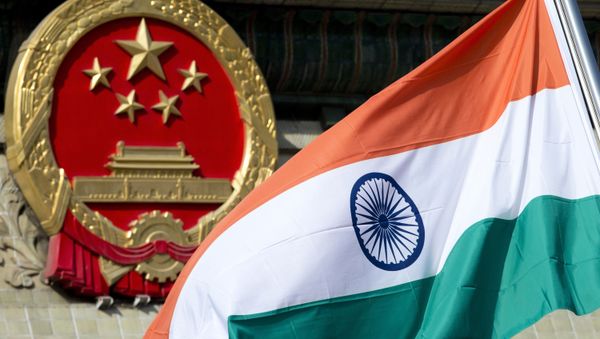 In this Oct. 23, 2013, file photo, an Indian national flag is flown next to the Chinese national emblem outside the Great Hall of the People in Beijing. China’s Commerce Ministry said Thursday, Aug. 13, 2020 it has extended punitive tariffs on Indian optical fiber products for five years. The announcement follows a yearlong review after a previous tariff expired in 2019 In this Oct. 23, 2013, file photo, an Indian national flag is flown next to the Chinese national emblem outside the Great Hall of the People in Beijing. China’s Commerce Ministry said Thursday, Aug. 13, 2020 it has extended punitive tariffs on Indian optical fiber products for five years. The announcement follows a yearlong review after a previous tariff expired in 2019 - Sputnik International