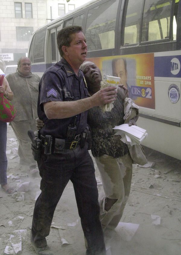 A police officer helps a woman to a bus after she fled the area near the World Trade Center towers on 11 September 2001, in New York A police officer helps a woman to a bus after she fled the area near the World Trade Center towers on 11 September 2001, in New York - Sputnik International