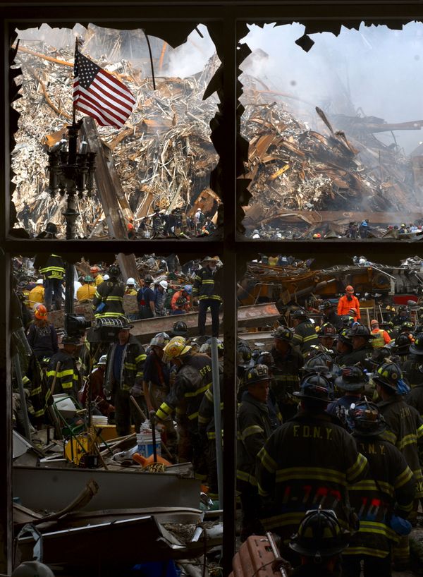 New York City firemen walk past the American flag as they work their way toward the heart of the devastation that was once the World Trade Center New York City firemen walk past the American flag as they work their way toward the heart of the devastation that was once the World Trade Center - Sputnik International