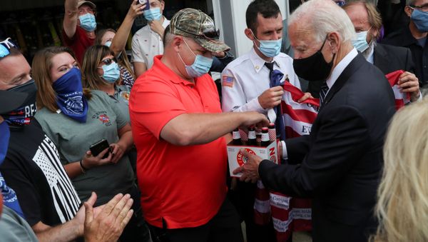 Democratic U.S. presidential nominee and former Vice President Joe Biden hands over a six pack of beer to Frank Barta that he said he brought for firefighters after promising to bring beer during a previous visit to Shanksville fire station number 627 long ago, as Biden stopped at the fire hall after visiting the nearby Flight 93 National Memorial to those killed when hijacked Flight 93 crashed into an open field on September 11, 2001, in Shanksville, Pennsylvania, September 11, 2020. Democratic U.S. presidential nominee and former Vice President Joe Biden hands over a six pack of beer to Frank Barta that he said he brought for firefighters after promising to bring beer during a previous visit to Shanksville fire station number 627 long ago, as Biden stopped at the fire hall after visiting the nearby Flight 93 National Memorial to those killed when hijacked Flight 93 crashed into an open field on September 11, 2001, in Shanksville, Pennsylvania, September 11, 2020. - Sputnik International