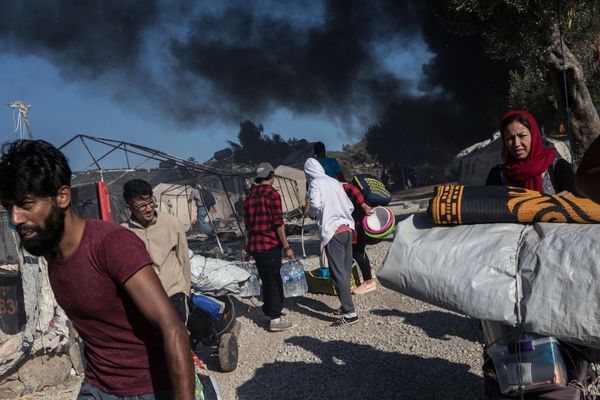 Migrants near the burned-out Moriah migrant camp on Lesbos, Greece Migrants near the burned-out Moriah migrant camp on Lesbos, Greece - Sputnik International