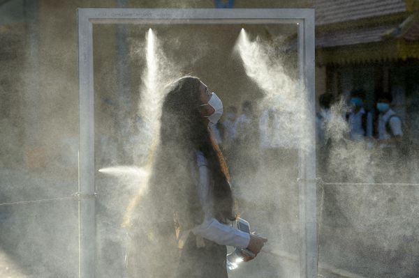 A face mask-clad student walks through a gate equipped with disinfectant spray as part of measures against the COVID-19 coronavirus in Phnom Penh on September 7, 2020, as schools reopen across the country A face mask-clad student walks through a gate equipped with disinfectant spray as part of measures against the COVID-19 coronavirus in Phnom Penh on September 7, 2020, as schools reopen across the country - Sputnik International