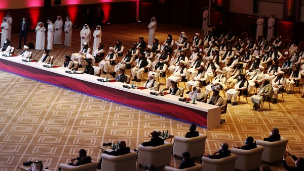 Delegates attend talks between the Afghan government and Taliban insurgents in Doha - Sputnik International