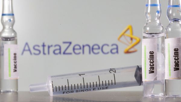 A test tube labelled with the Vaccine is seen in front of AstraZeneca logo in this illustration taken, September 9, 2020 - Sputnik International