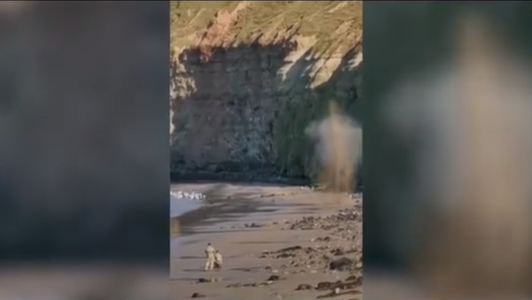Screenshot from a video showing a bomb disposal team detonating an old grenade in Cat Nab, Saltburn, UK - Sputnik International