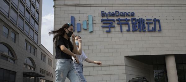 Women wearing masks to prevent the spread of the coronavirus chat as they pass by the ByteDance headquarters in Beijing, China on Friday, Aug. 7, 2020. President Donald Trump on Thursday ordered a sweeping but unspecified ban on dealings with the Chinese owners of consumer apps TikTok and WeChat, although it remains unclear if he has the legal authority to actually ban the apps from the U.S. TikTok is owned by Chinese company ByteDance - Sputnik International