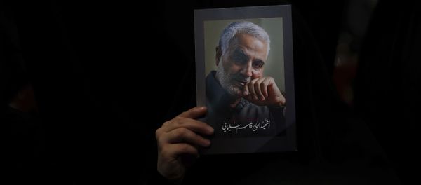A Hezbollah supporter holds pictures of slain Iranian Revolutionary Guard Gen. Qassem Soleimani during a ceremony marking the anniversary of the assassination of Hezbollah leaders, Abbas al-Moussawi, Ragheb Harb and Imad Mughniyeh and the end of a 40-day Muslim mourning period for Soleimani, in the southern suburb of Beirut, Lebanon, Sunday, Feb. 16, 2020 - Sputnik International