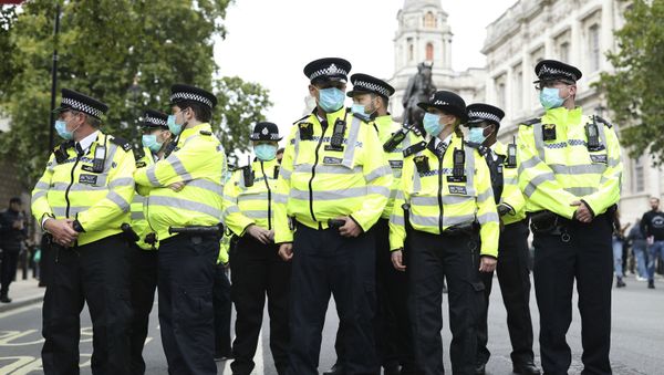 Police officers wearing face masks stand guard during a protest opposed to COVID-19 pandemic restrictions, in Trafalgar Square, London, 29 August, 2020 - Sputnik International