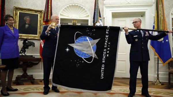 Chief of Space Operations at US Space Force Gen. John Raymond, center, and Chief Master Sgt. Roger Towberman, right, hold the United States Space Force flag as it is presented in the Oval Office of the White House, Friday, May 15, 2020, in Washington.  Secretary of the Air Force Barbara Barrett stands far left. - Sputnik International