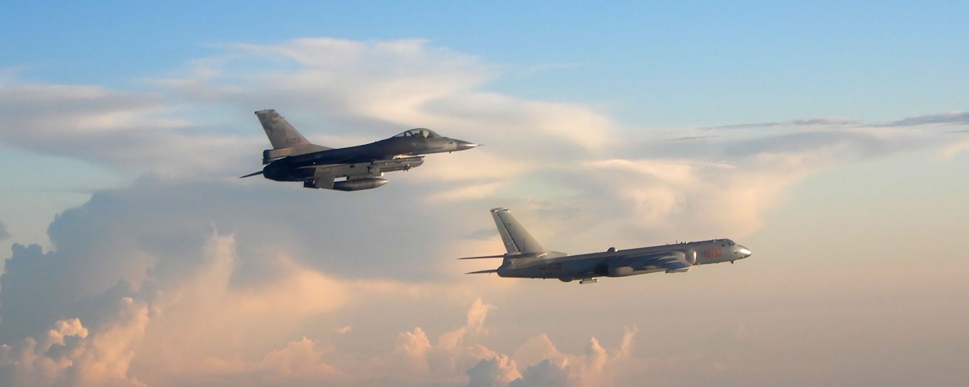 In this photo taken and released Friday, May 25, 2018, by the Taiwan Ministry of National Defense, a Taiwanese Air Force fighter aircraft, left, flies near a Chinese People's Liberation Army Air Force (PLAAF) bomber that reportedly flew over the Luzon Strait south of Taiwan.  - Sputnik International, 1920, 10.10.2021