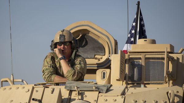 A U.S. soldier observes form the top of a fighting vehicle at a US military base at undisclosed location in Northeastern Syria, Monday, Nov. 11, 2019. - Sputnik International