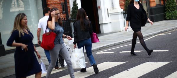 A woman wears a protective face mask as she walks on a street, amid the spread of the coronavirus disease (COVID-19) in Chelsea, London, Britain September 22, 2020 - Sputnik International