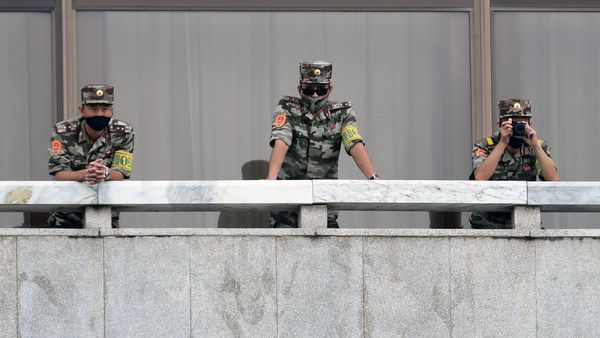 North Korean soldiers keep watch toward the south as South Korean Unification Minister Lee In-young inspects (not pictured) the truce village of Panmunjom inside the demilitarized zone separating the two Koreas, South Korea, September 16, 2020 - Sputnik International