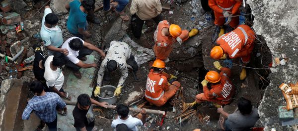 FILE PHOTO: National Disaster Response Force (NDRF) officials search for survivors as people help clear the rubble after a three-storey building collapsed in Bhiwandi, on the outskirts of Mumbai, India, September, 21 2020. FILE PHOTO: National Disaster Response Force (NDRF) officials search for survivors as people help clear the rubble after a three-storey building collapsed in Bhiwandi, on the outskirts of Mumbai, India, September, 21 2020. - Sputnik International
