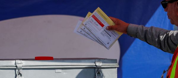 An election worker places mail-in ballots into an election box at a drive-through drop off location at the Registrar of Voters in San Diego, California, U.S. November 5, 2018. An election worker places mail-in ballots into an election box at a drive-through drop off location at the Registrar of Voters in San Diego, California, U.S. November 5, 2018. - Sputnik International